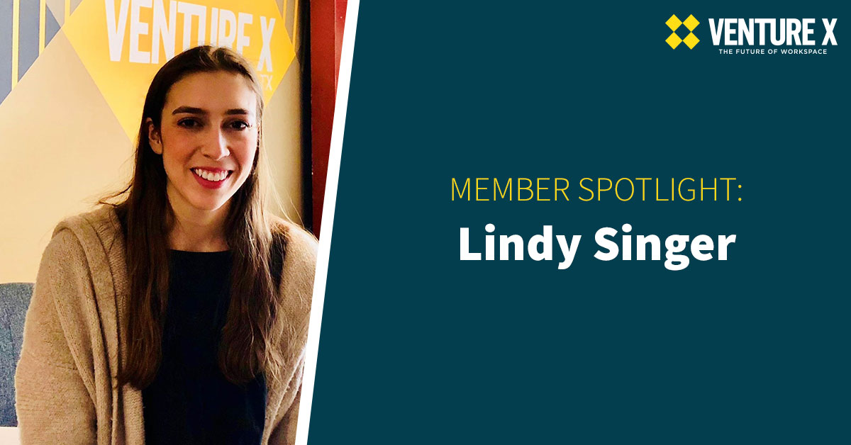 A woman smiles at the camera beside a Venture X sign, representing the vibrant coworking community. Text reads "Member Spotlight: Lindy Singer.
