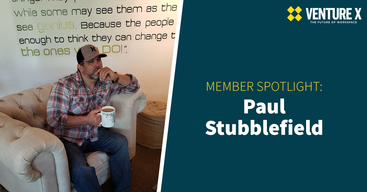 Man sitting on a couch holding a coffee mug, with "MEMBER SPOTLIGHT: Paul Stubblefield" text beside him. As part of our flexible workspace community, Paul's insights into creating the perfect office space inspire us all.