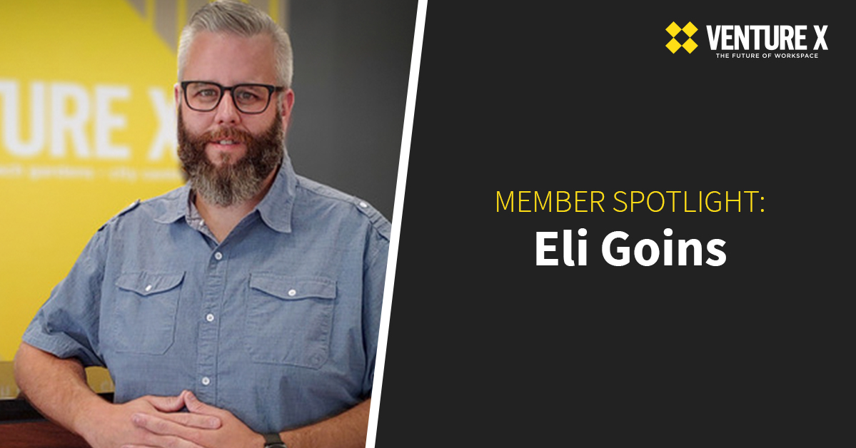 Man with a beard and glasses stands in front of a Venture X sign. Text reads: "Member Spotlight: Eli Goins, embracing the potential of flexible workspace.