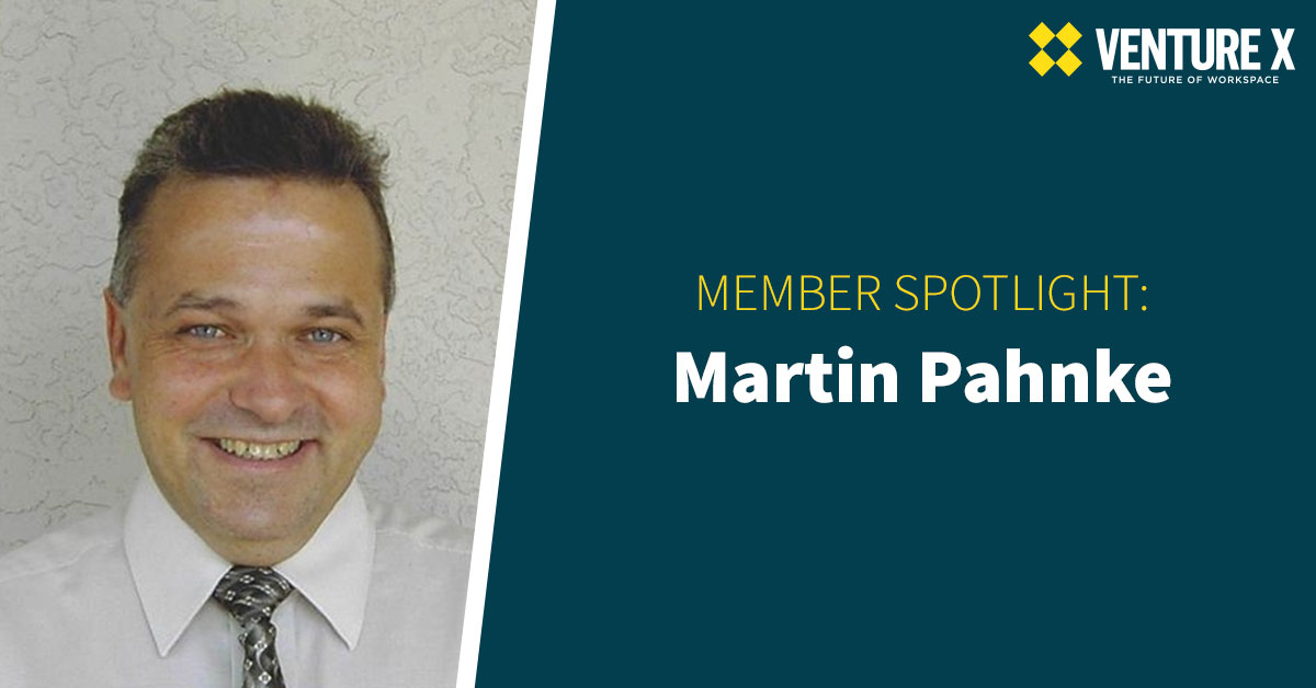 Smiling man in a white shirt and patterned tie, with text: "Member Spotlight: Martin Pahnke" and "Venture X - The Future of Coworking Space.
