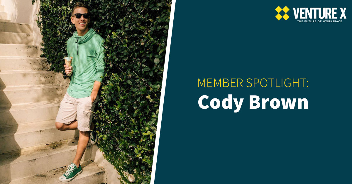 A person in sunglasses leans against stairs holding an ice cream cone