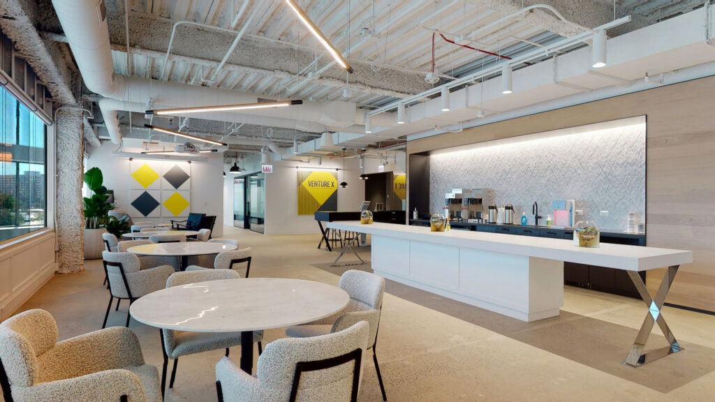 Spacious Venture X Oakbrook coworking area with tables and chairs, seating areas, coffee and beverage stations. 
